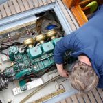 A,Service,Engineer,Fixing,The,Engine,Of,A,Vessel A,Service,Engineer,Fixing,The,Engine,Of,A,Vessel